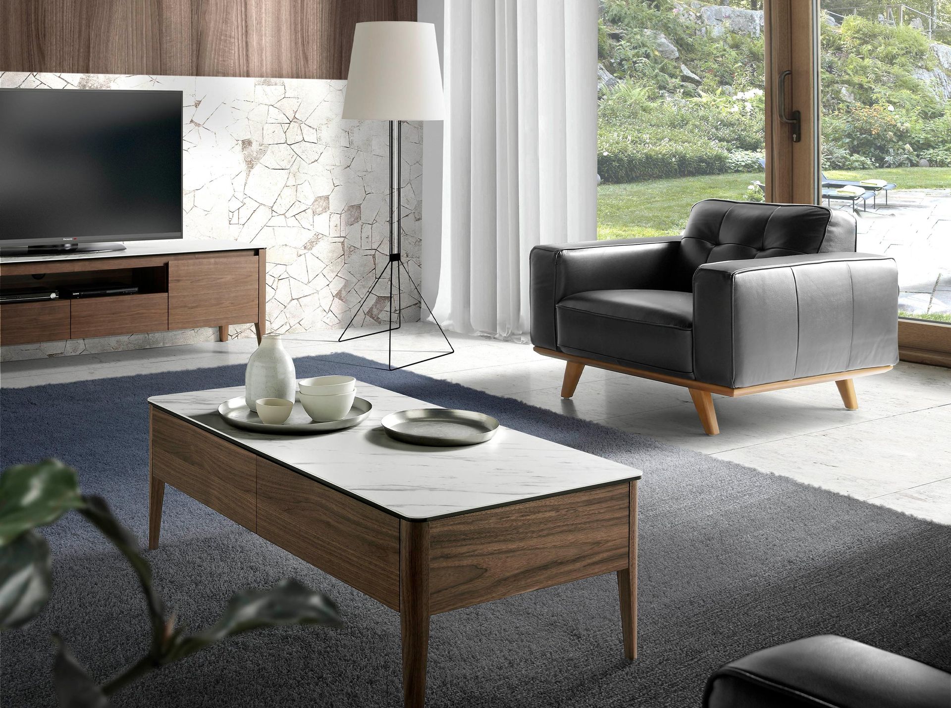 Sessel (Noun)
    Leder (Material)
    Schwarz (Color)

    Italian:
    Poltrona (Noun)
    Chester (Style)
    Pelle (Material)
    Nera (Color)

    This is the standard way.

    One more thing: "Chester" is sometimes used as "Chesterfield".
    