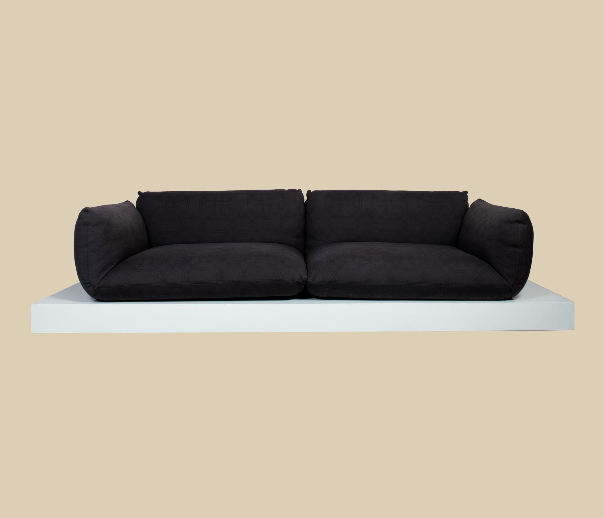 Sofa Jalis von COR Schwarz mit Ton in Ton Muster auf Podest